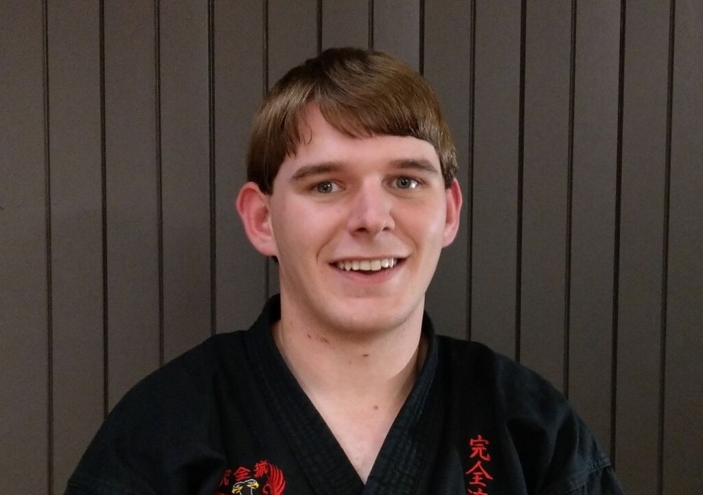 Senpai Will Searle smiling at camera in karate gi